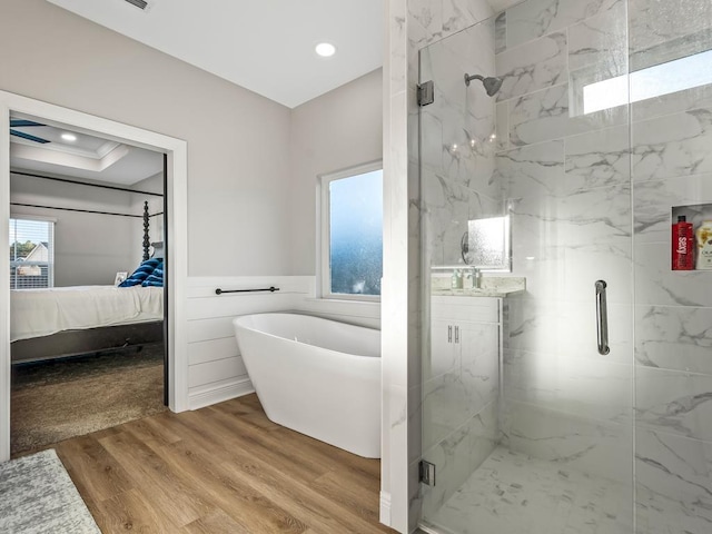 bathroom featuring wood-type flooring and independent shower and bath