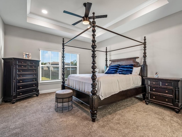 bedroom featuring carpet, a raised ceiling, ceiling fan, and crown molding