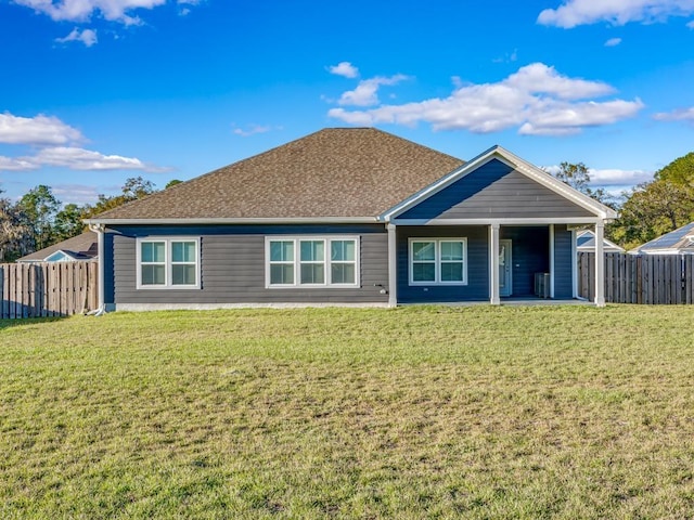 back of house with a lawn