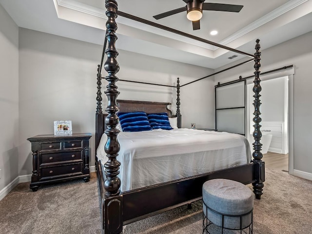 bedroom with a raised ceiling, ceiling fan, crown molding, and dark colored carpet