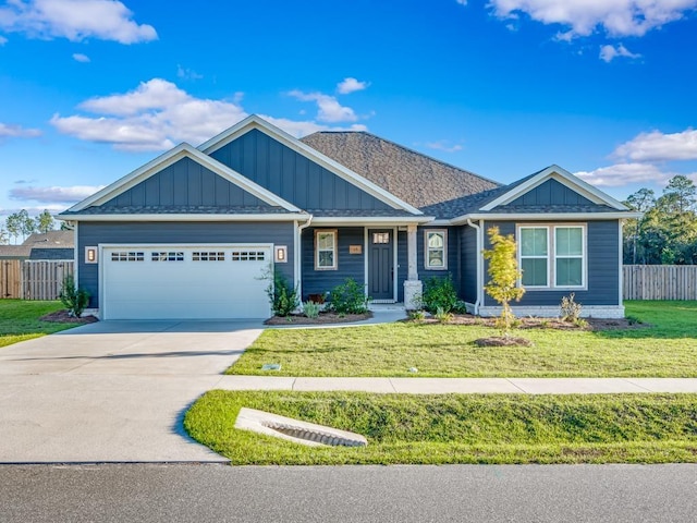 craftsman house featuring a garage and a front yard