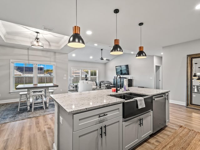 kitchen with dishwasher, a kitchen island with sink, crown molding, ceiling fan, and decorative light fixtures