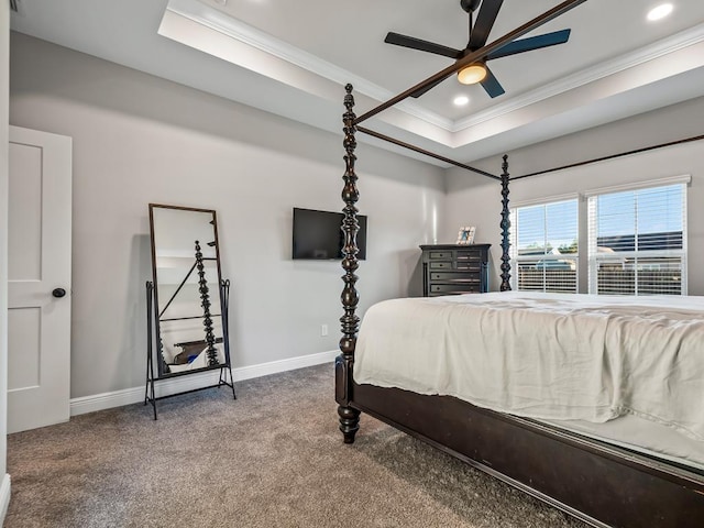 bedroom featuring ceiling fan, a raised ceiling, carpet floors, and ornamental molding