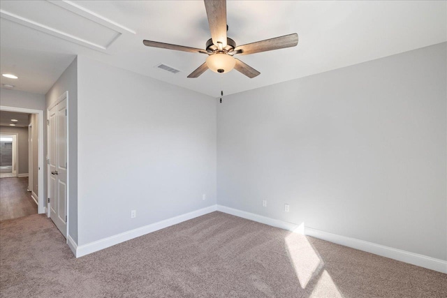 empty room with ceiling fan and light carpet