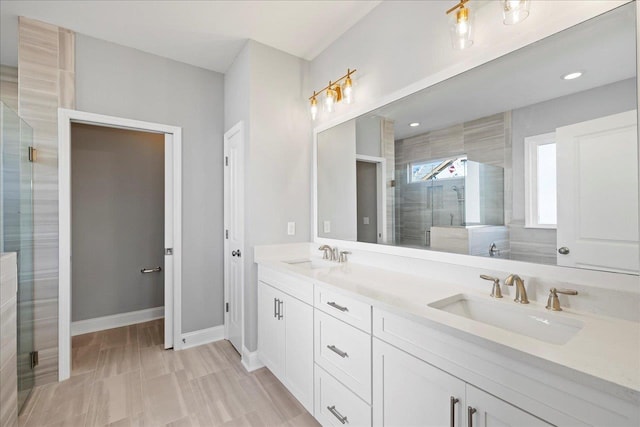 bathroom with a shower with shower door and vanity