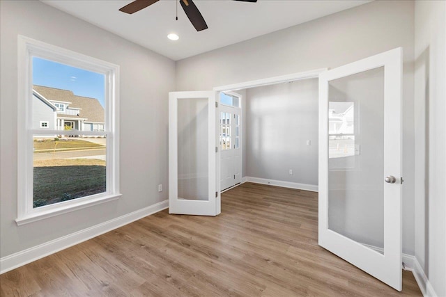 unfurnished bedroom with french doors, ceiling fan, and light hardwood / wood-style flooring