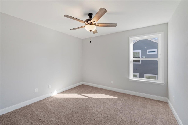 carpeted empty room featuring ceiling fan