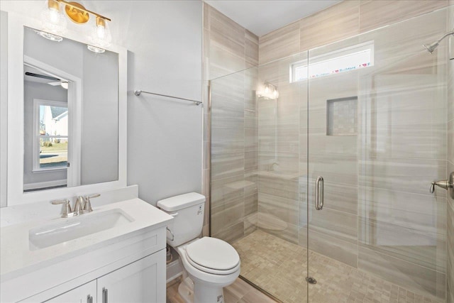 bathroom with toilet, vanity, and walk in shower