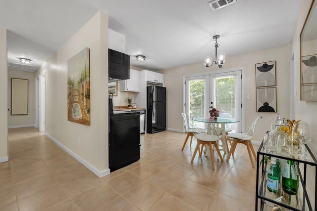 2917 Greenon Ln, Tallahassee, FL 32304 - dining room with baseboards, french doors, light tile patterned flooring, and a chandelier