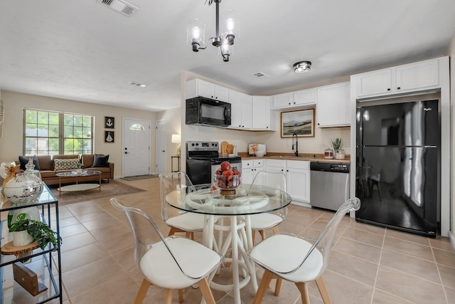2917 Greenon Ln, Tallahassee, FL 32304 - kitchen featuring black appliances, a sink, white cabinets, and light tile patterned flooring