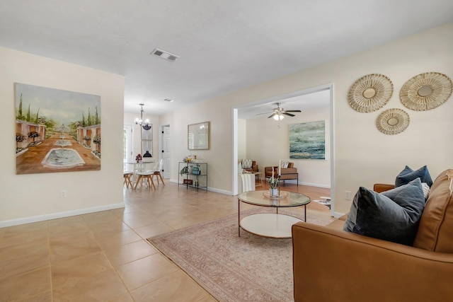 2917 Greenon Ln, Tallahassee, FL 32304 - living room featuring a chandelier, baseboards, light tile patterned floors, and ceiling fan