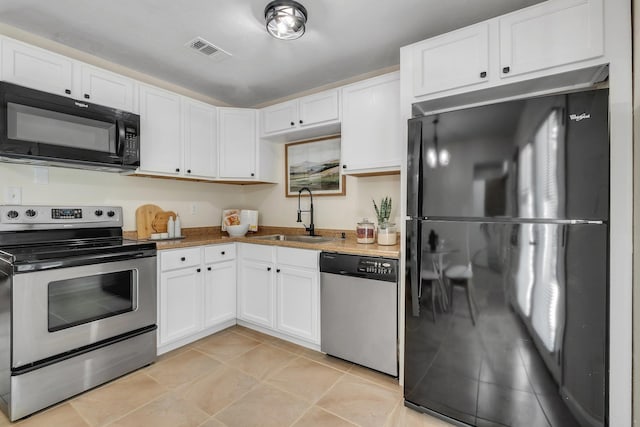 2917 Greenon Ln, Tallahassee, FL 32304 - kitchen with black appliances, a sink, and white cabinetry