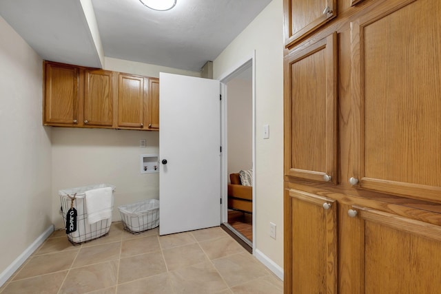 2917 Greenon Ln, Tallahassee, FL 32304 - laundry room with cabinet space, hookup for a washing machine, light tile patterned flooring, and baseboards