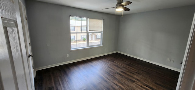 spare room with dark hardwood / wood-style flooring and ceiling fan