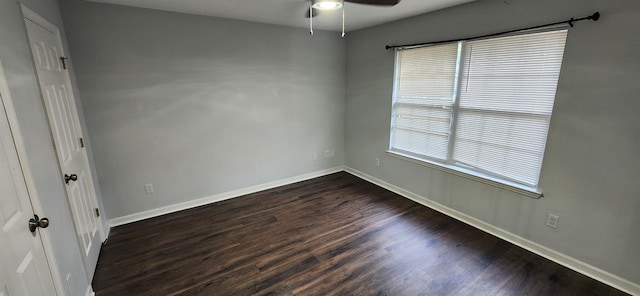 unfurnished room with dark hardwood / wood-style floors and ceiling fan