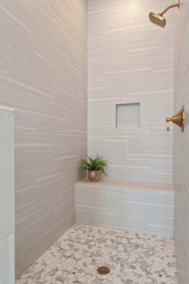 full bath featuring a tile shower