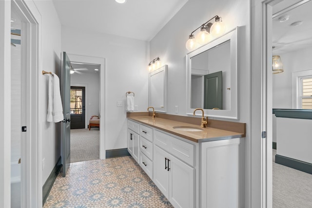 full bath with double vanity, plenty of natural light, and a sink