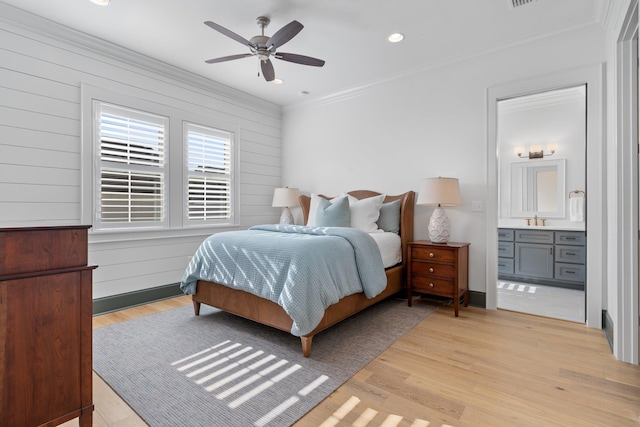 bedroom featuring crown molding, recessed lighting, ensuite bath, and light wood-style floors