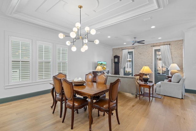 dining room with crown molding, light wood-style flooring, and baseboards