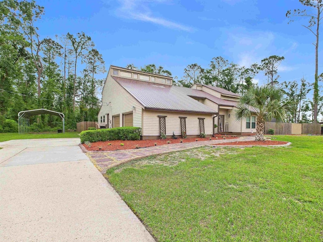 310 Glenridge Rd, Perry, FL 32348 - view of front facade with a carport, metal roof, and driveway
