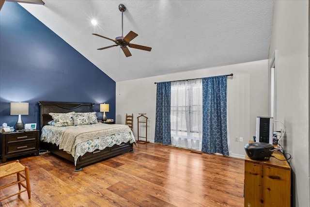 310 Glenridge Rd, Perry, FL 32348 - bedroom with wood finished floors, a textured ceiling, baseboards, high vaulted ceiling, and ceiling fan