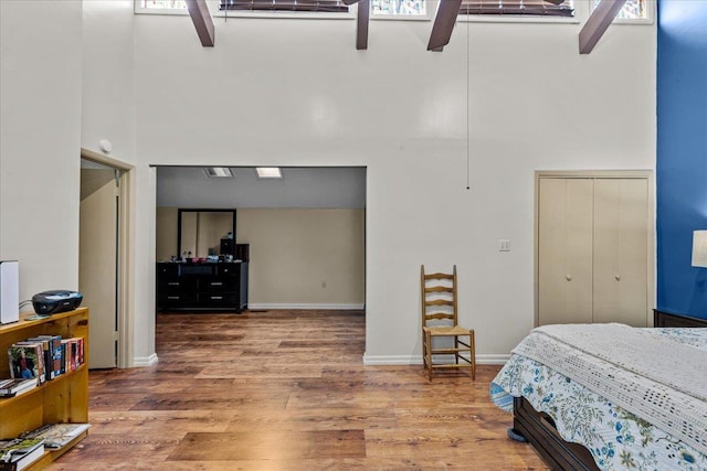 310 Glenridge Rd, Perry, FL 32348 - bedroom with a high ceiling, wood finished floors, baseboards, and a ceiling fan