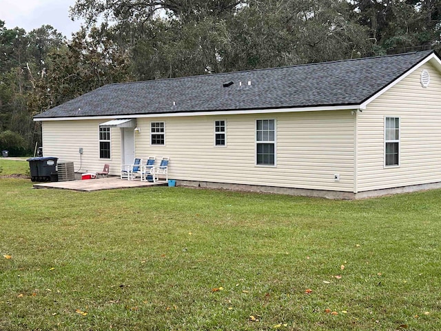 rear view of house featuring a patio and a yard