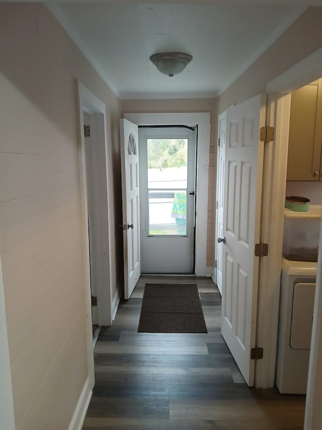 doorway to outside with washer / dryer and dark wood-type flooring