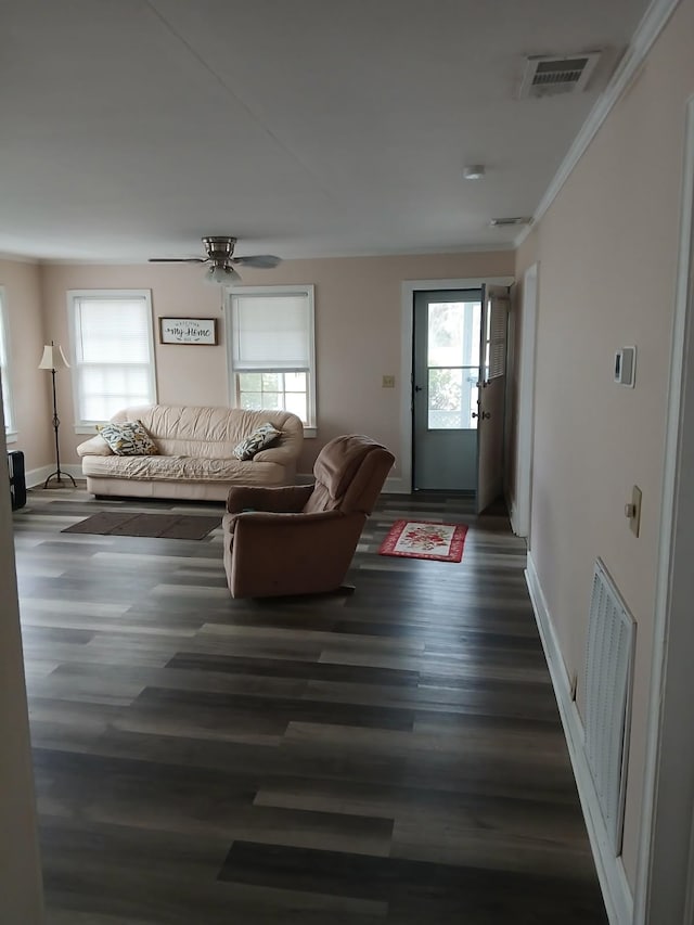 unfurnished living room featuring ornamental molding, dark hardwood / wood-style floors, and ceiling fan