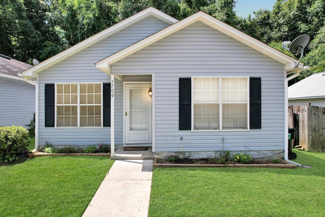 bungalow-style house with a front yard