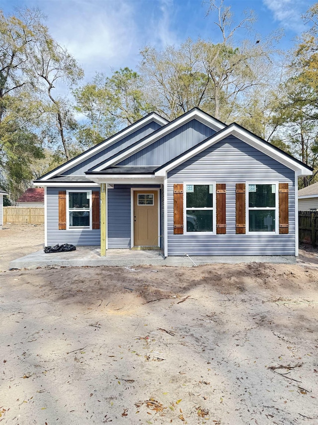 view of front of home featuring fence