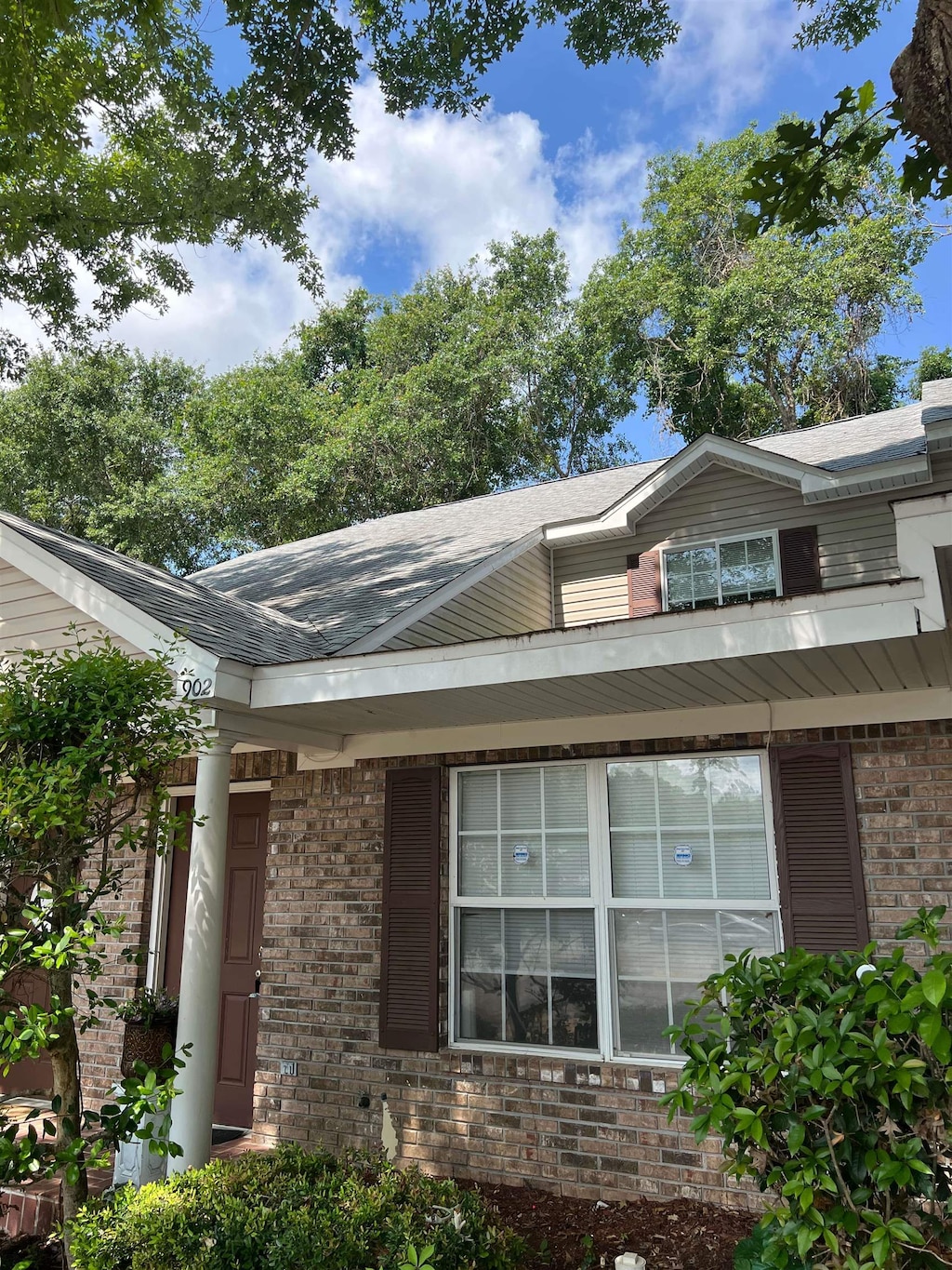 2738 W Tharpe St Unit 902, Tallahassee, FL 32303 - view of front facade with brick siding and roof with shingles