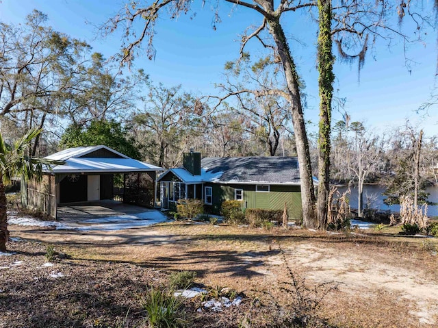 ranch-style home featuring a carport and a water view