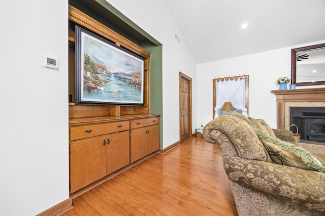 living room featuring vaulted ceiling and light wood-type flooring