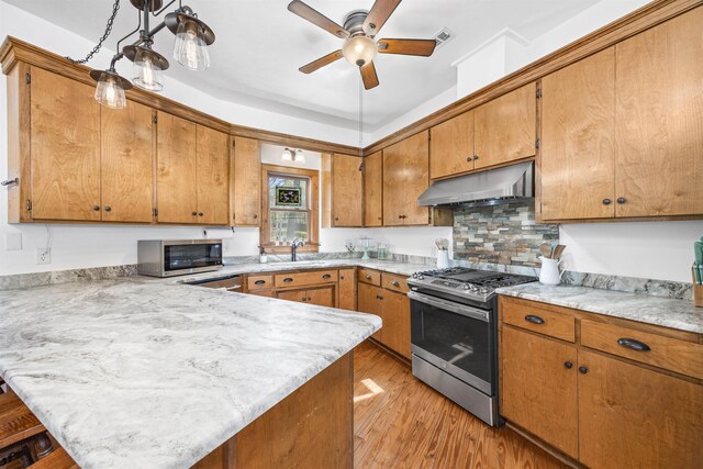 bedroom featuring ornamental molding, wood-type flooring, ensuite bathroom, and ceiling fan