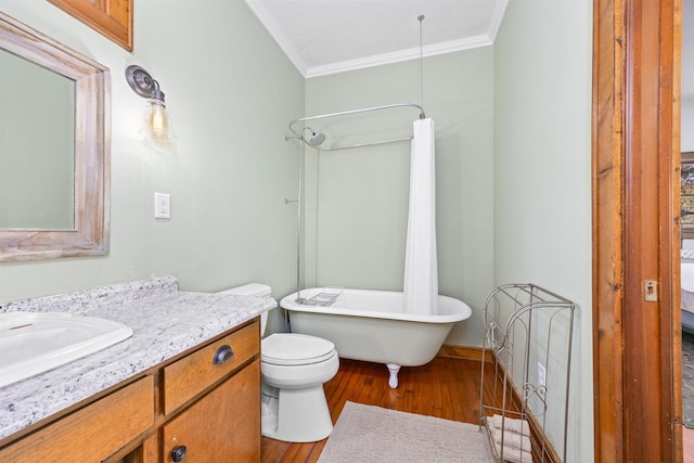 bathroom with vanity, hardwood / wood-style flooring, ornamental molding, and toilet