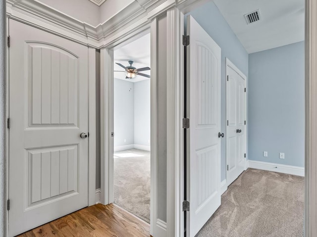 hall featuring light colored carpet