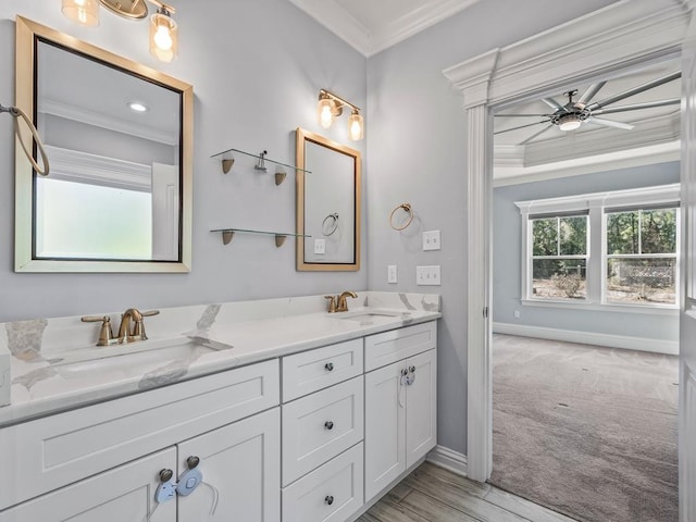 bathroom with ornamental molding, vanity, and ceiling fan