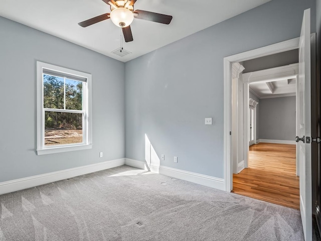 carpeted spare room with ceiling fan