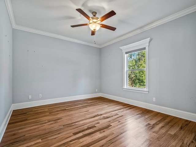 empty room featuring ornamental molding, hardwood / wood-style floors, and ceiling fan