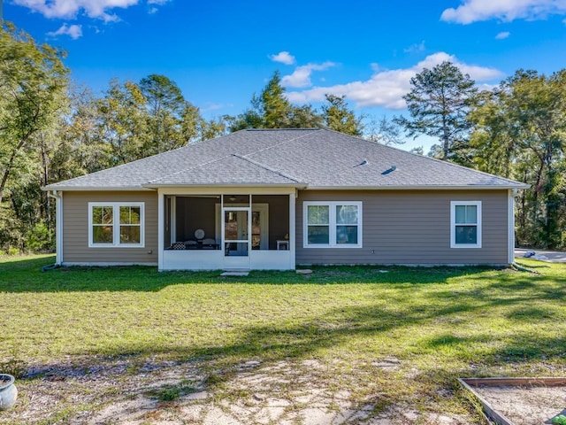 back of house with a sunroom and a lawn