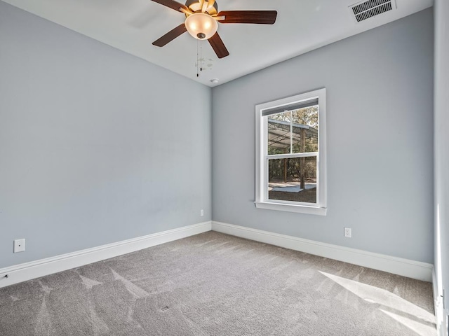 carpeted spare room featuring ceiling fan