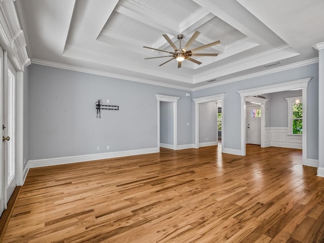 interior space featuring ceiling fan, ornamental molding, coffered ceiling, and light wood-type flooring