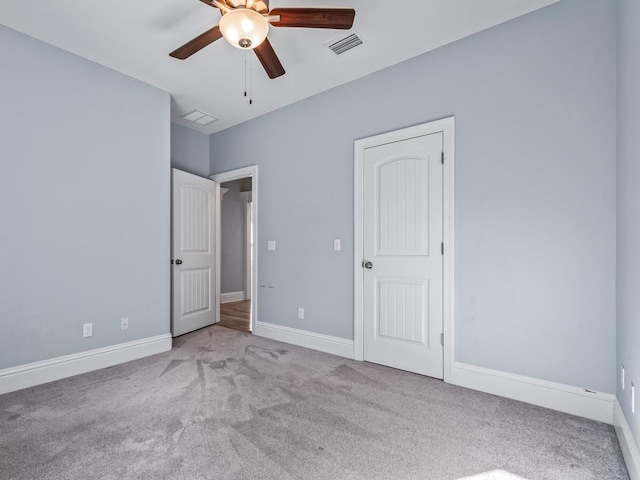 unfurnished bedroom featuring ceiling fan and light colored carpet