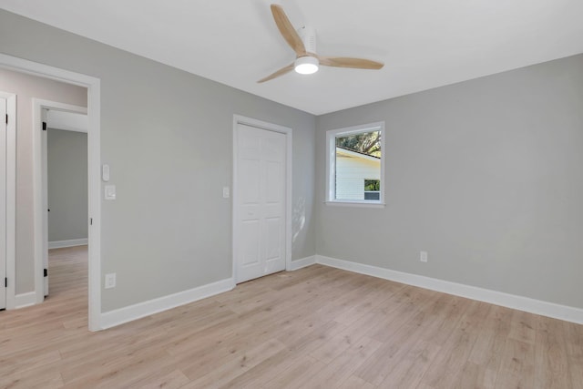 unfurnished bedroom featuring ceiling fan, a closet, and light hardwood / wood-style floors