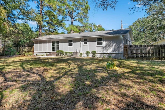 rear view of property featuring a yard