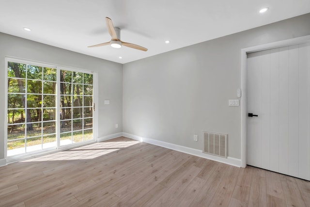 unfurnished room with ceiling fan and light wood-type flooring