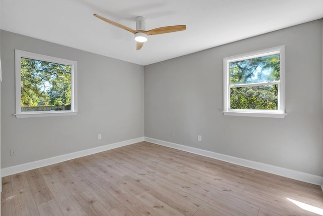 empty room with ceiling fan and light wood-type flooring