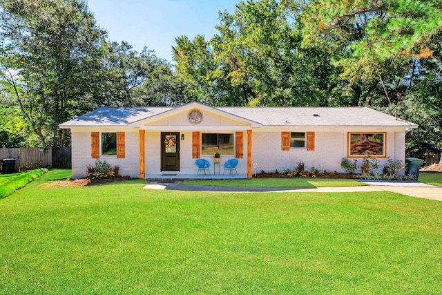 single story home with a front lawn and covered porch