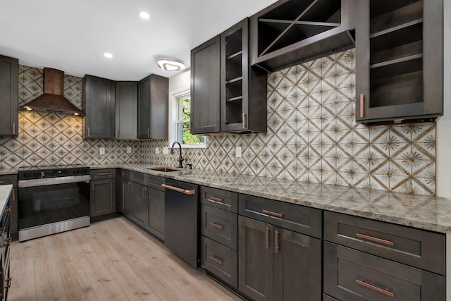 kitchen with dishwasher, custom exhaust hood, sink, range with electric cooktop, and light stone counters